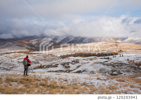 Hiker explores snowy Altai Mountains in stunning winter landscape Hiker explores snowy Altai Mountains in stunning winter landscape 120283941