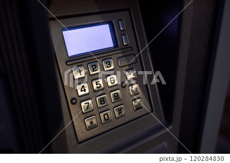 Close-up view of a numeric keypad with metallic buttons and illuminated screen on a secure electronic device Close-up view of a numeric keypad with metallic buttons and illuminated screen on a secure electronic device 120284830