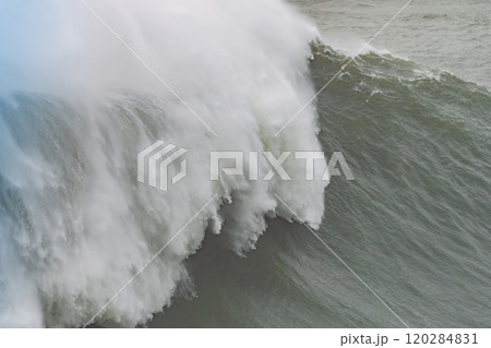 A colossal wave crashing with immense power and spray in Nazare, Portugal A colossal wave crashing with immense power and spray in Nazare, Portugal 120284831