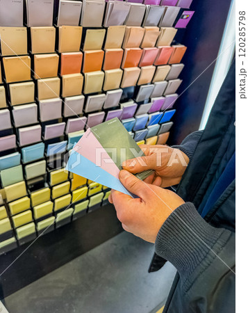 Customer Selecting Paint Swatches in Colourful Hardware Store Display. High quality photo Customer Selecting Paint Swatches in Colourful Hardware Store Display. High quality photo 120285798