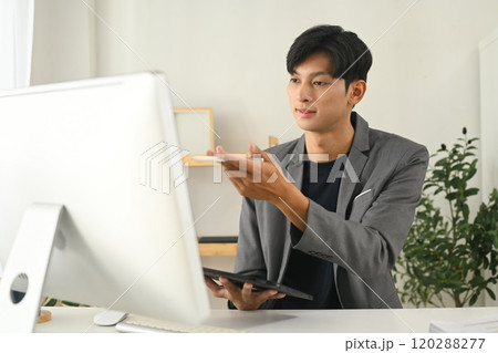 Handsome millennial businessman communicating in an online meeting 120288277
