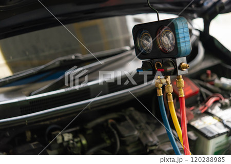 Car refilling air condition at car garage 120288985