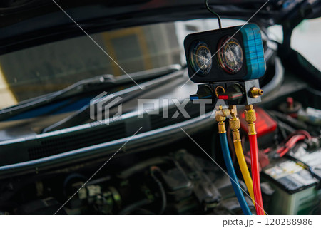 Car refilling air condition at car garage 120288986