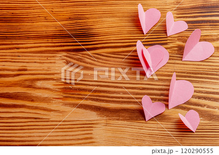Composition of pink hearts on a wooden background 120290555