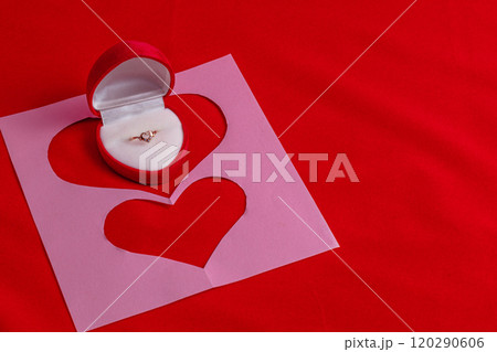 Concept of love note, proposal with cut out hearts and wedding ring 120290606