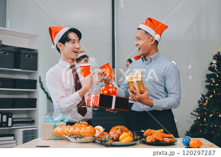 full length view of a group of business team wearing red Santa hat and exchange gift box together in the office for Christmas. full length view of a group of business team wearing red Santa hat and exchange gift box together in the office for Christmas. 120297287