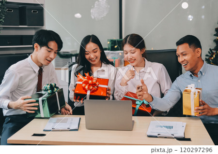 full length view of a group of business team wearing red Santa hat and exchange gift box together in the office for Christmas. full length view of a group of business team wearing red Santa hat and exchange gift box together in the office for Christmas. 120297296
