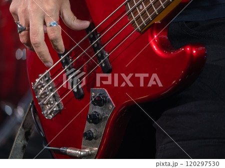 Musician playing electric bass guitar during live performance 120297530