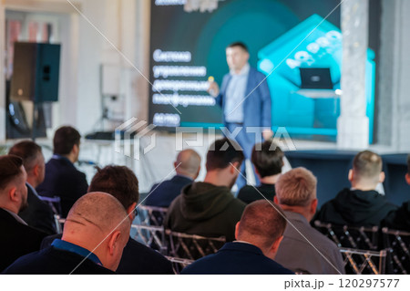 Audience attentively listening to business presentation in auditorium 120297577