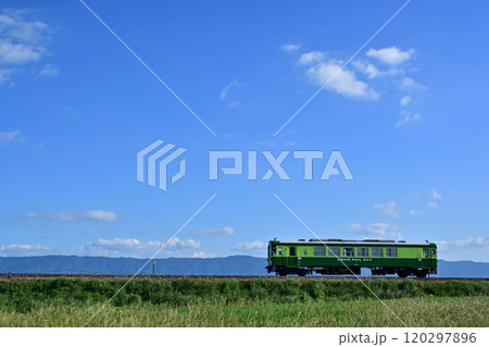 青空のもと走る緑色列車 120297896