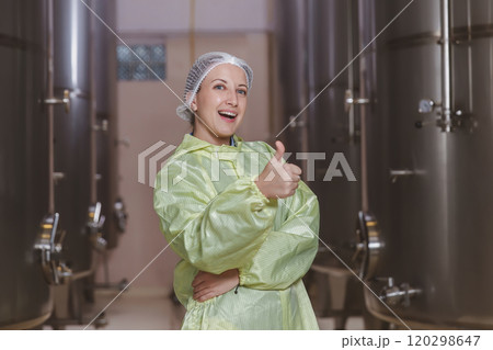 Winemaker working in modern large winery factory liquor drink industry quality. Staff inspecting wine in modern wine factory. Winery manufacturing quality control. Alcohol and wine winemaking process 120298647