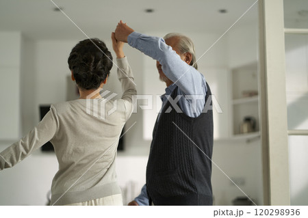 loving asian old couple dancing at home loving asian old couple dancing at home 120298936