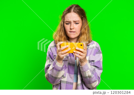 Happy woman playing racing drive simulator, shooter video games on smartphone, celebrate victory win 120301284