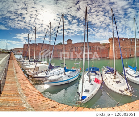 View of Fortezza Nuova and marina in Livorno with boats docked under a partly cloudy sky 120302051