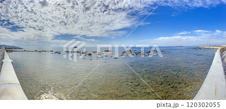 View from Livorno promenade overlooking the sea with clear water and rocky shore under a partly cloudy sky View from Livorno promenade overlooking the sea with clear water and rocky shore under a partly cloudy sky 120302055