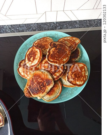 Freshly tasty stack of pancakes on the plate, maple syrup and blueberries isolated on a white background. Delicious homemade breakfast or lunch. Directly above 120302133