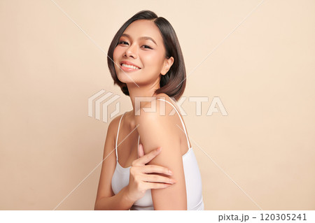 Beautiful young asian woman with clean fresh skin on beige background, Face care, Facial treatment, Cosmetology, beauty and spa, Asian women portrait. 120305241