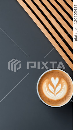 Artfully crafted latte with heart design on a blue wooden table during a cozy morning 120305437