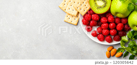Fresh Fruits and Snacks on a Light Surface Fresh Fruits and Snacks on a Light Surface 120305642