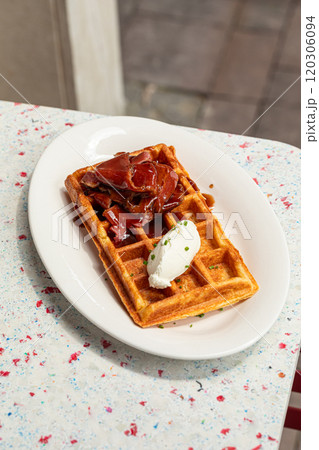 Portion of waffle with brisket and cream cheese Portion of waffle with brisket and cream cheese 120306094
