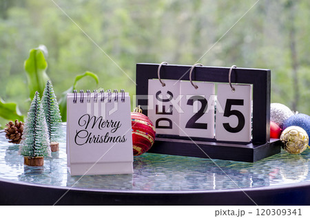 Merry Christmas text on white notepad with simple Christmas decoration background. Christmas celebration concept. 120309341