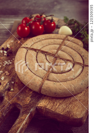 raw spiral sausages, on a wooden board, top view, no people, 120309395