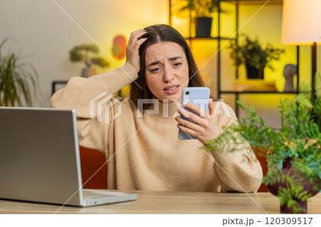 Sad pretty woman use smartphone surprised by bad news, fortune loss, fail, lottery results, deadline Sad pretty woman use smartphone surprised by bad news, fortune loss, fail, lottery results, deadline 120309517