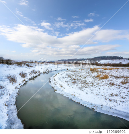 Winter landscape by a river in the sunset. 120309601