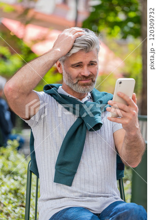 Mature man use smartphone application game casino lottery loses bad news messages fortune loss fail Mature man use smartphone application game casino lottery loses bad news messages fortune loss fail 120309732