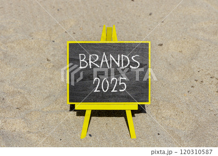 Planning brands 2025 new year symbol. Concept words Brands 2025 on beautiful yellow chalk blackboard. Beautiful sand beach background. Business brands 2025 new year concept. Copy space. 120310587