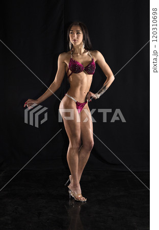 Beautiful athletic girl on a dark background 120310698