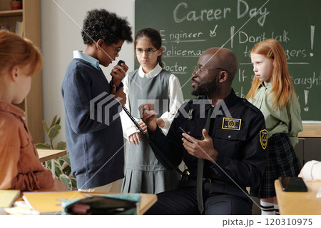 Schoolboy speaking in walkie-talkie Schoolboy speaking in walkie-talkie 120310975