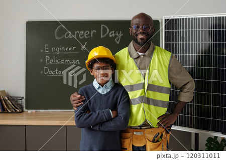 Engineer and schoolboy by solar panel Engineer and schoolboy by solar panel 120311011