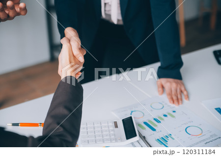 Handshake in agreement against young business people in board room meeting 120311184