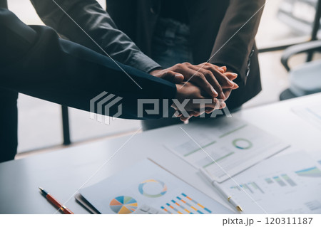 Handshake in agreement against young business people in board room meeting 120311187