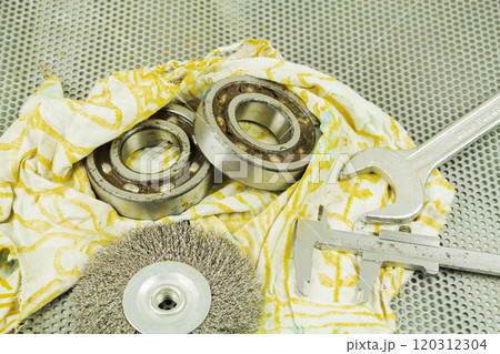 Metalworking tools, steel parts, a wrench, on the background of a metal lattice. Metalworking tools, steel parts, a wrench, on the background of a metal lattice. 120312304