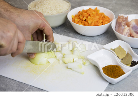 A cutting board with bowls of chicken, carrots, onions, rice A cutting board with bowls of chicken, carrots, onions, rice 120312306