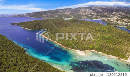 Epirus, Greece. Sivota - stunning aerial drone video of turquoise sea known as Blue Lagoon and unique beach Bella Vraka.  120312816