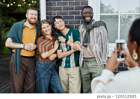 Multiethnic group of adult people posing for photo outdoors and smiling happily enjoying party with friends Multiethnic group of adult people posing for photo outdoors and smiling happily enjoying party with friends 120312885