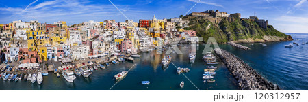 Italy travel and landmarks. Most scenic and colorful island - beautiful Procida in gulf of Naples. Port of Corricella panoramic view with yellow church 120312957