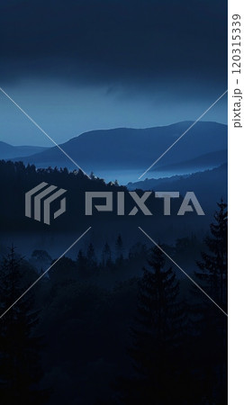 Vibrant sunset colors over a mountain vista with a lone tree in the foreground. Nature's majesty concept. 120315339