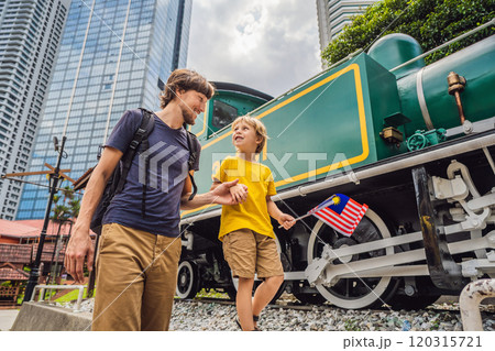 Father and son travelers in malaysia with malaysia flag celebrating the Malaysia independence day and Malaysia day. Travel to Malaysia concept 120315721