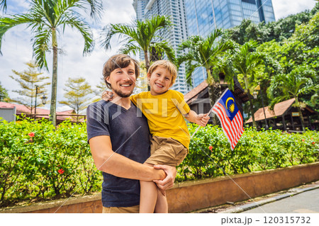 Father and son travelers in malaysia with malaysia flag celebrating the Malaysia independence day and Malaysia day. Travel to Malaysia concept 120315732