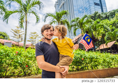 Father and son travelers in malaysia with malaysia flag celebrating the Malaysia independence day and Malaysia day. Travel to Malaysia concept Father and son travelers in malaysia with malaysia flag celebrating the Malaysia independence day and Malaysia day. Travel to Malaysia concept 120315733