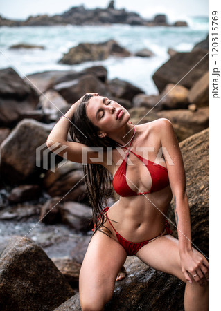 Experience Serene Beachside Relaxation in a Vibrant Red Bikini by the Oceans Embrace Experience Serene Beachside Relaxation in a Vibrant Red Bikini by the Oceans Embrace 120315769