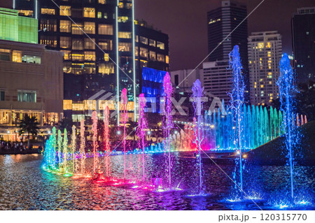 The colorful fountain on the lake at night, near by Twin Towers with city on background. Kuala Lumpur, Malaysia The colorful fountain on the lake at night, near by Twin Towers with city on background. Kuala Lumpur, Malaysia 120315770