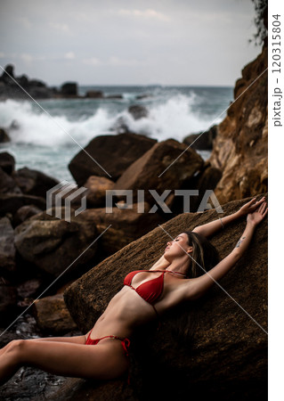 Experience Serene Beachside Relaxation in a Vibrant Red Bikini by the Oceans Embrace Experience Serene Beachside Relaxation in a Vibrant Red Bikini by the Oceans Embrace 120315804