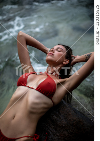 A Relaxing Woman in a Bikini Enjoying Her Time by the Beautiful Beach and Ocean Waves 120315825