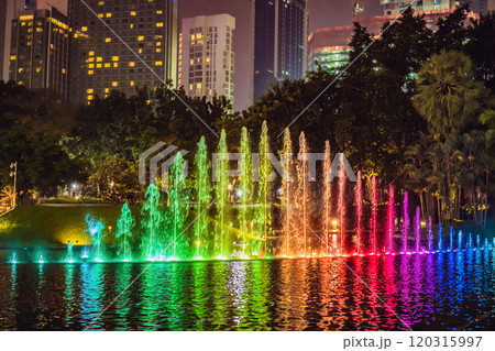 The colorful fountain on the lake at night, near by Twin Towers with city on background. Kuala Lumpur, Malaysia 120315997