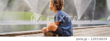Boy on background of Fountain on the lake in the evening, near by Twin Towers with city on background. Kuala Lumpur, Malaysia BANNER, LONG FORMAT 120316034